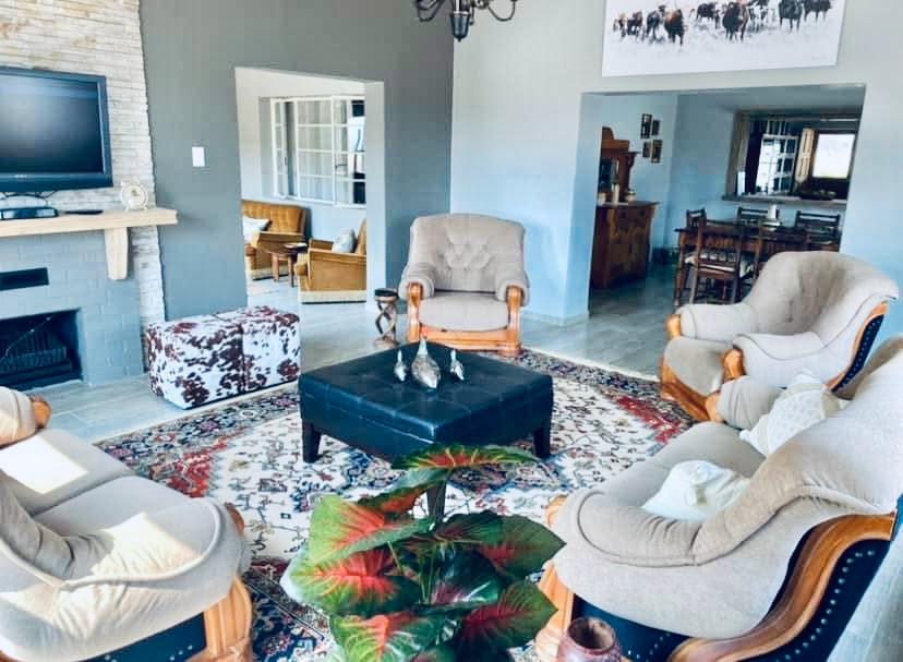 The Soetblomspan sitting room with deep couches and a fireplace