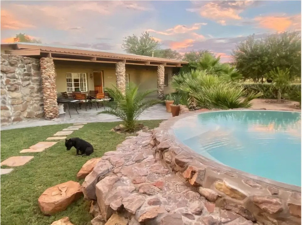 The Poolside Room and stone splash pool at Soetblomspan at sunset